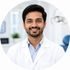 Professional dentist Dr. Rahul Sharma in a modern dental clinic in Alwar Rajasthan.